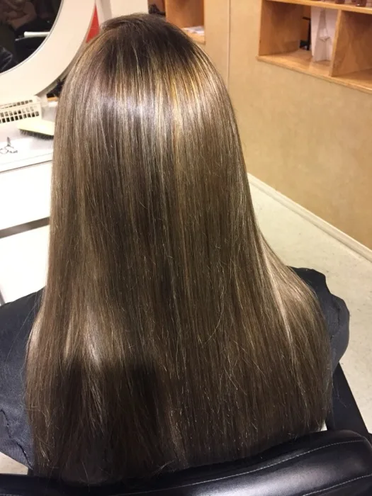 Sleek balayage highlighted hair styled at Creative Cuts Plus