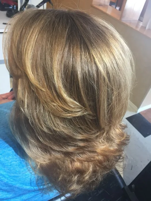 Blonde wavy styled updo at Creative Cuts Plus