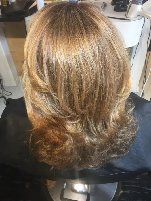 Blonde wavy blowout styled at Creative Cuts Plus