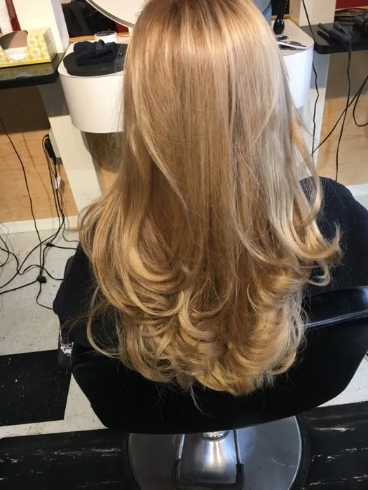 Long blonde wavy hairstyle at Creative Cuts Plus